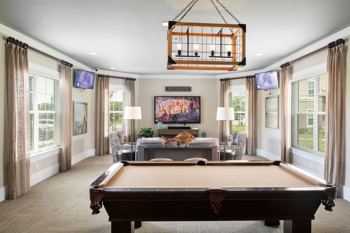 Game room with billiards table, lounge seating, and wall mounted TV