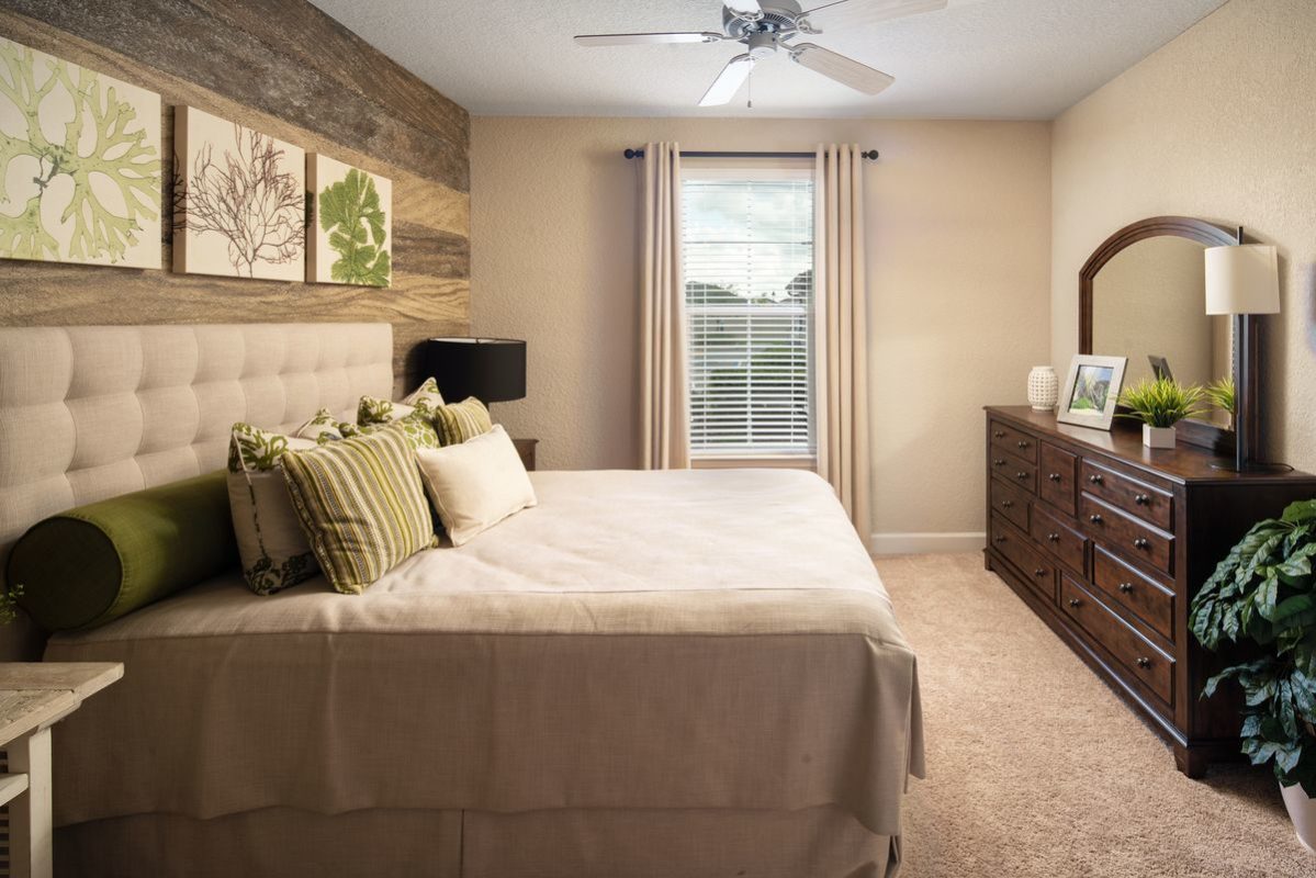 Furnished bedroom with carpet floor, ceiling fan with light, and one window